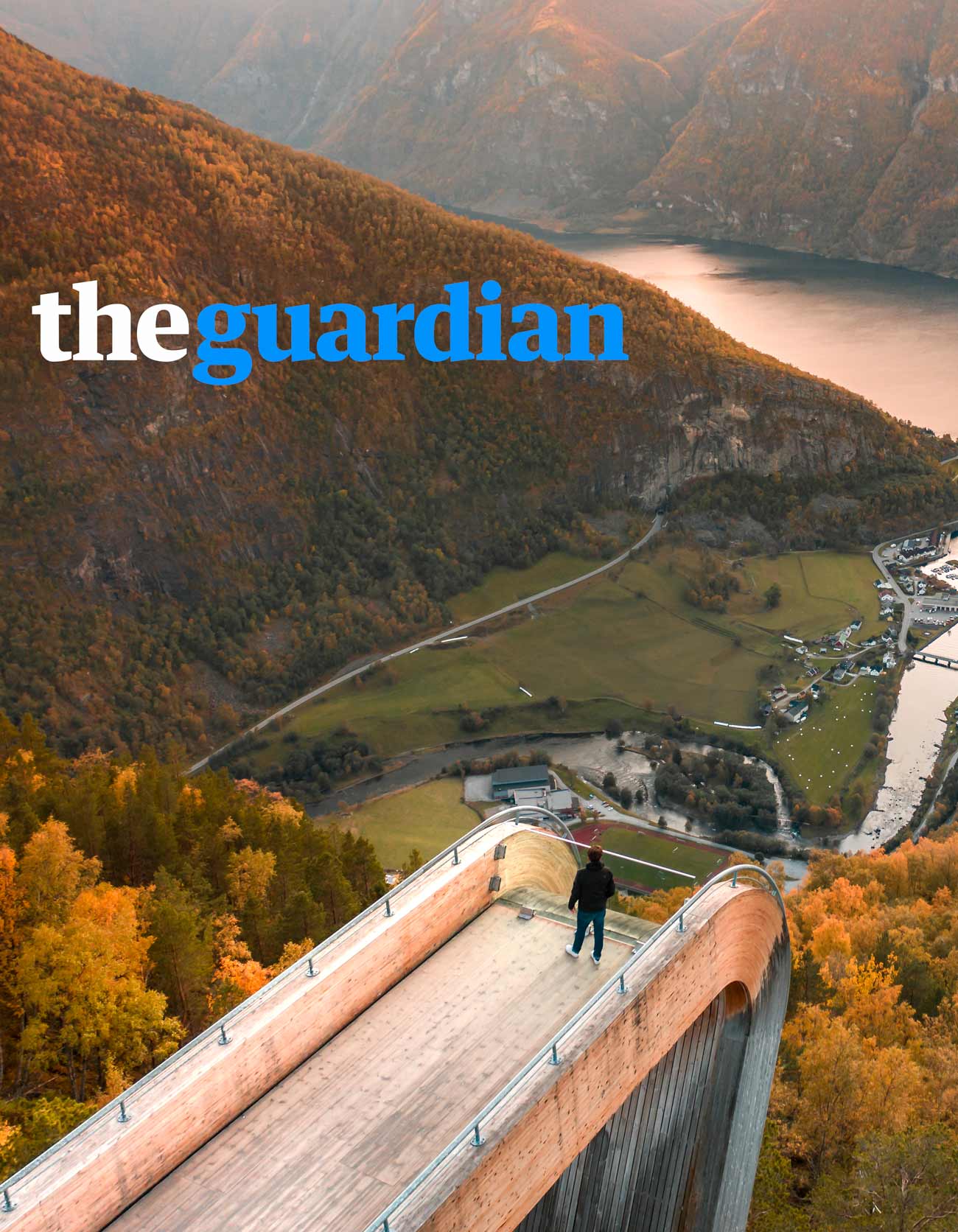 travel article with person looking over fjord in norway taken by a drone