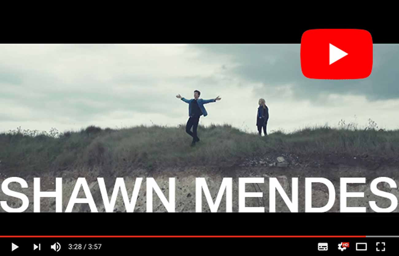 singer stood on cliff in music video filmed by drone