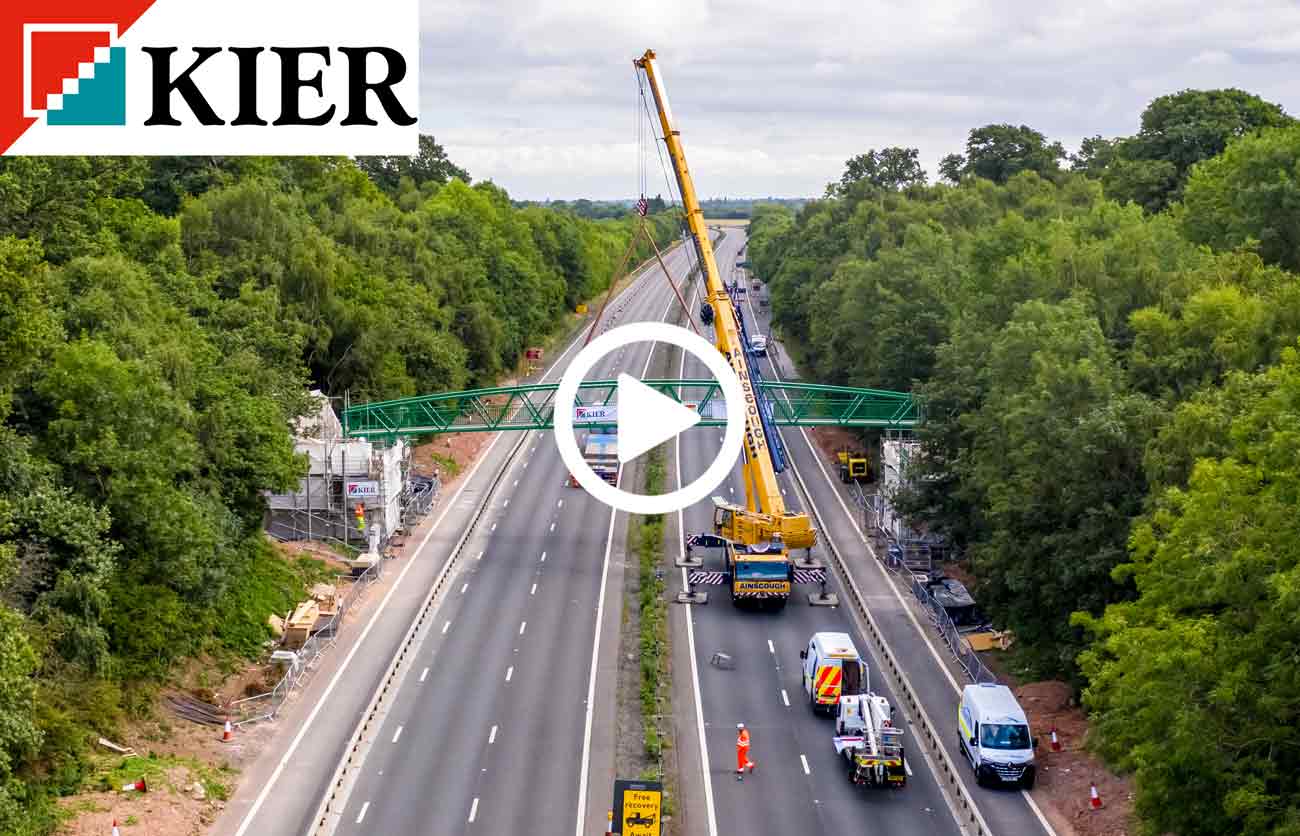 highways bridge being moved by a crane seen from a drone